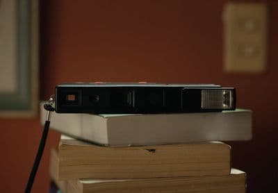 a camera sitting on top of a stack of books
