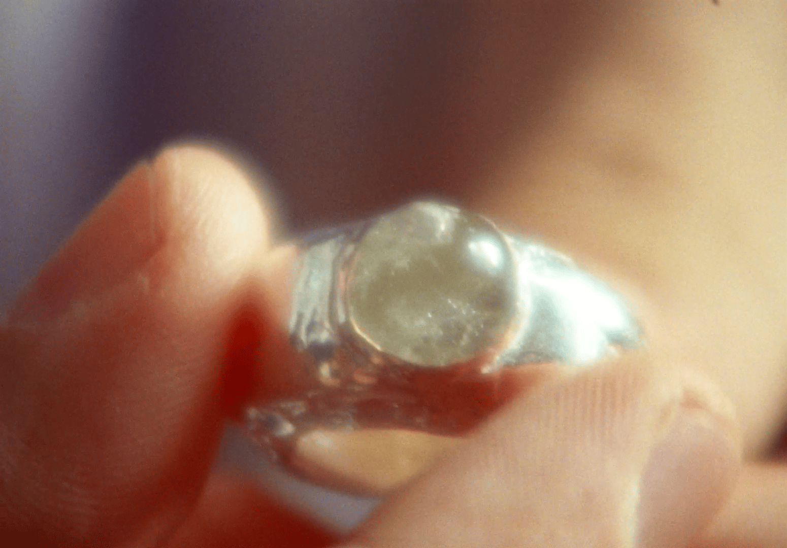 a close up of a person holding a ring