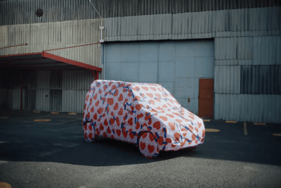a car covered in a large piece of paper