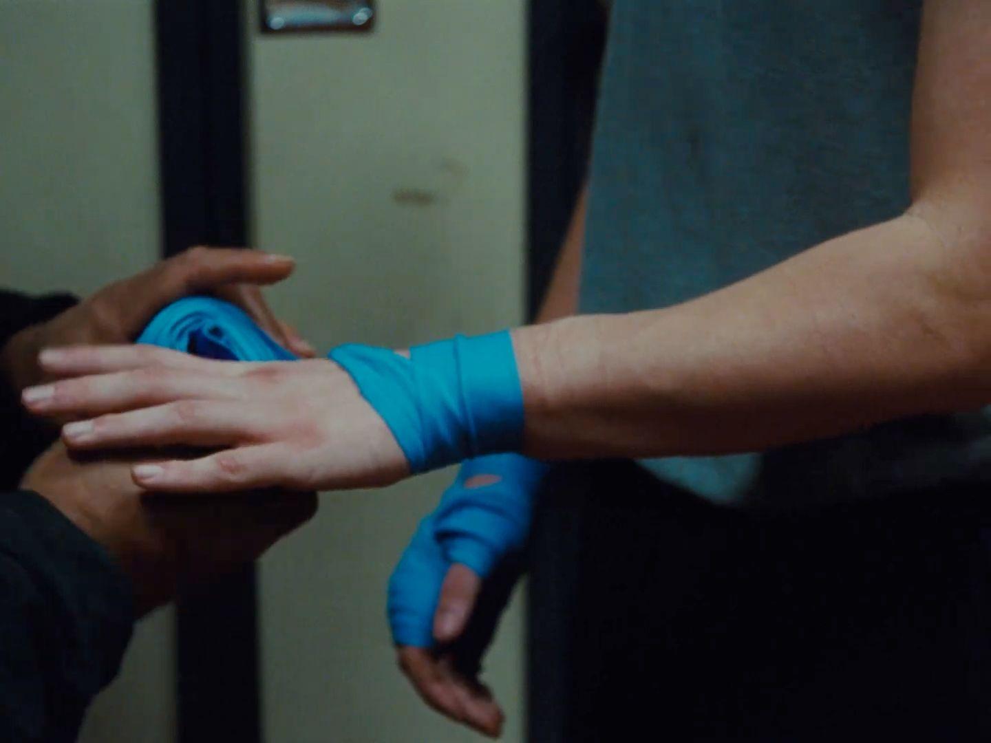 a person wearing blue gloves and a pair of blue gloves