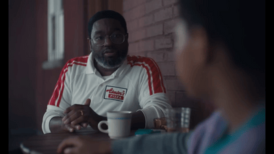 a man sitting at a table with a cup of coffee