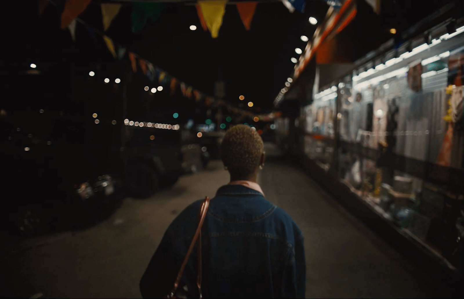 a man walking down a street at night