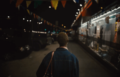 a man walking down a street at night