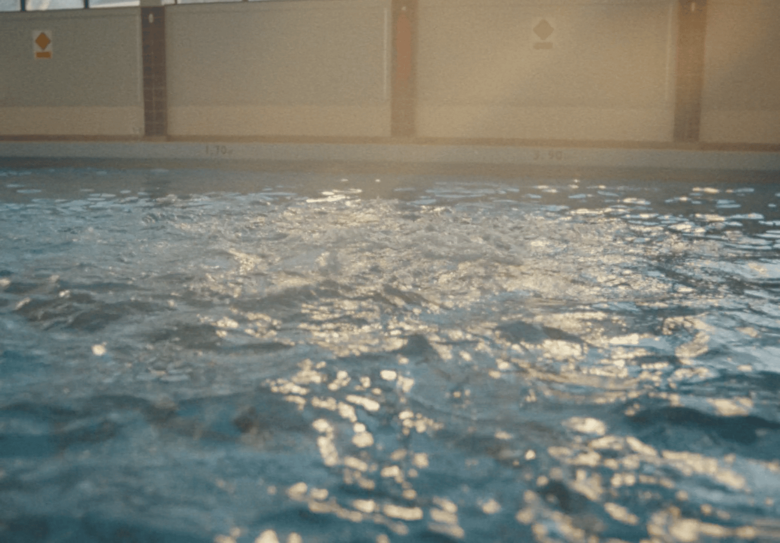 a large swimming pool with clear blue water