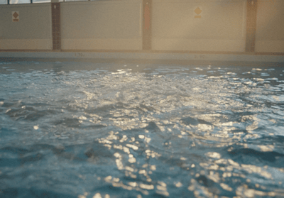 a large swimming pool with clear blue water