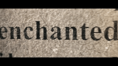 a close up of the word enchanted on a wall