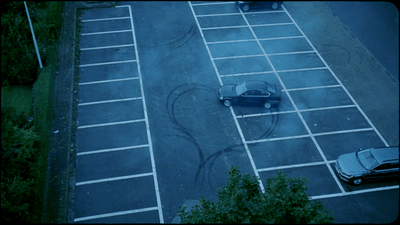 a parking lot with a car parked in it