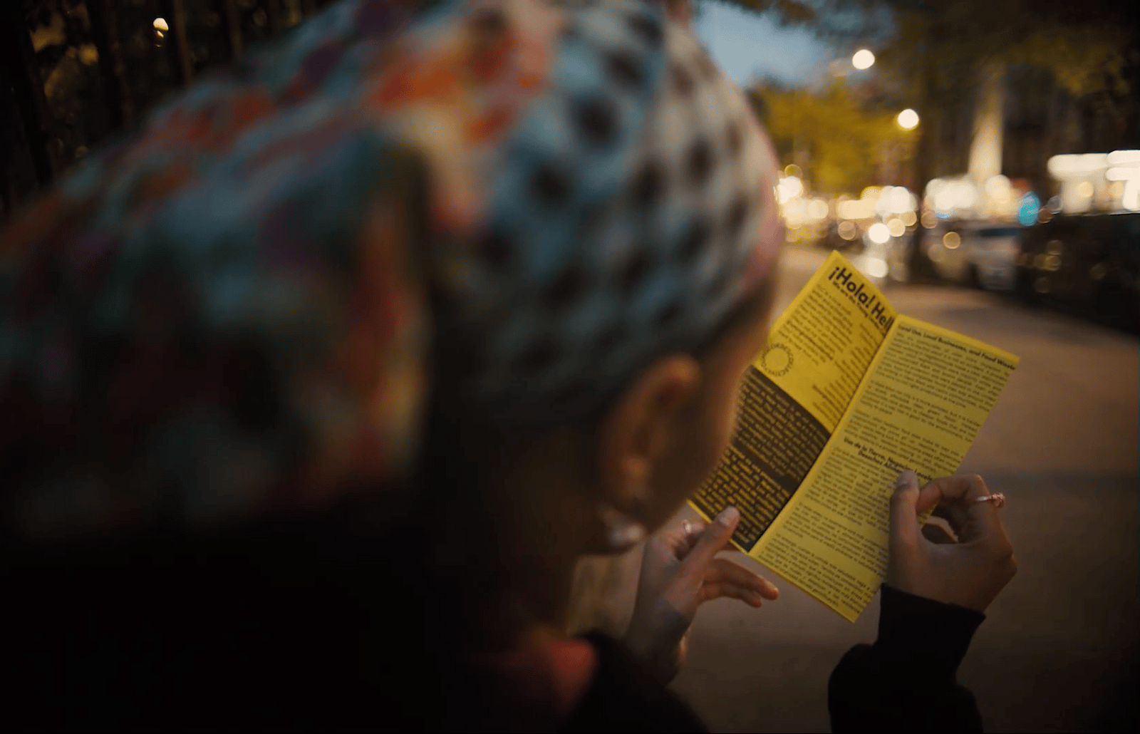 a woman reading a book on the side of the road