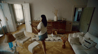 a woman is standing in a living room