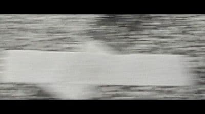a blurry photo of a person holding a surfboard