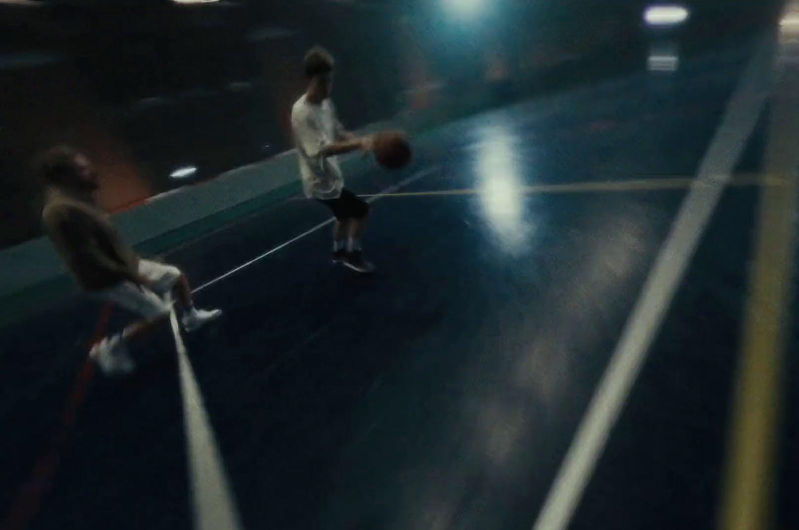 two men are playing basketball on a court