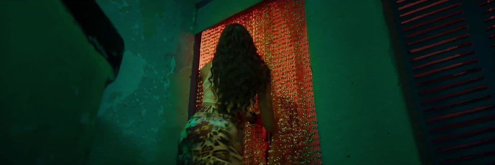 a woman standing in front of a red curtain
