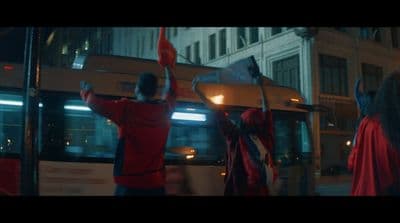 a group of people standing next to a bus