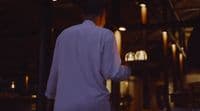a man holding a tray with candles on it