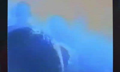 a blurry picture of a large wave in the ocean