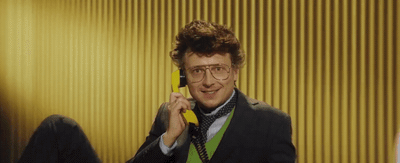 a man in a suit talking on a phone