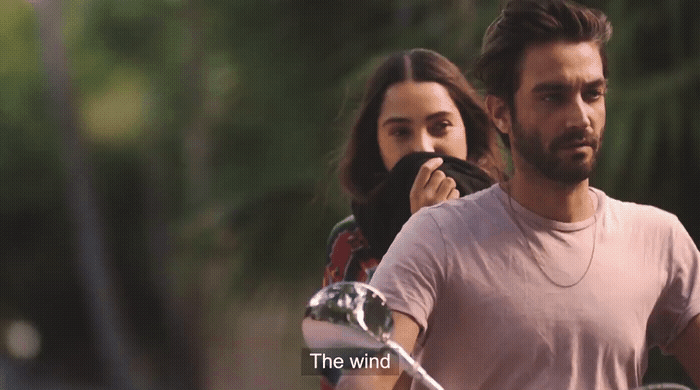 a man and a woman riding a motorcycle