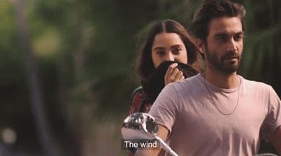 a man and a woman riding a motorcycle