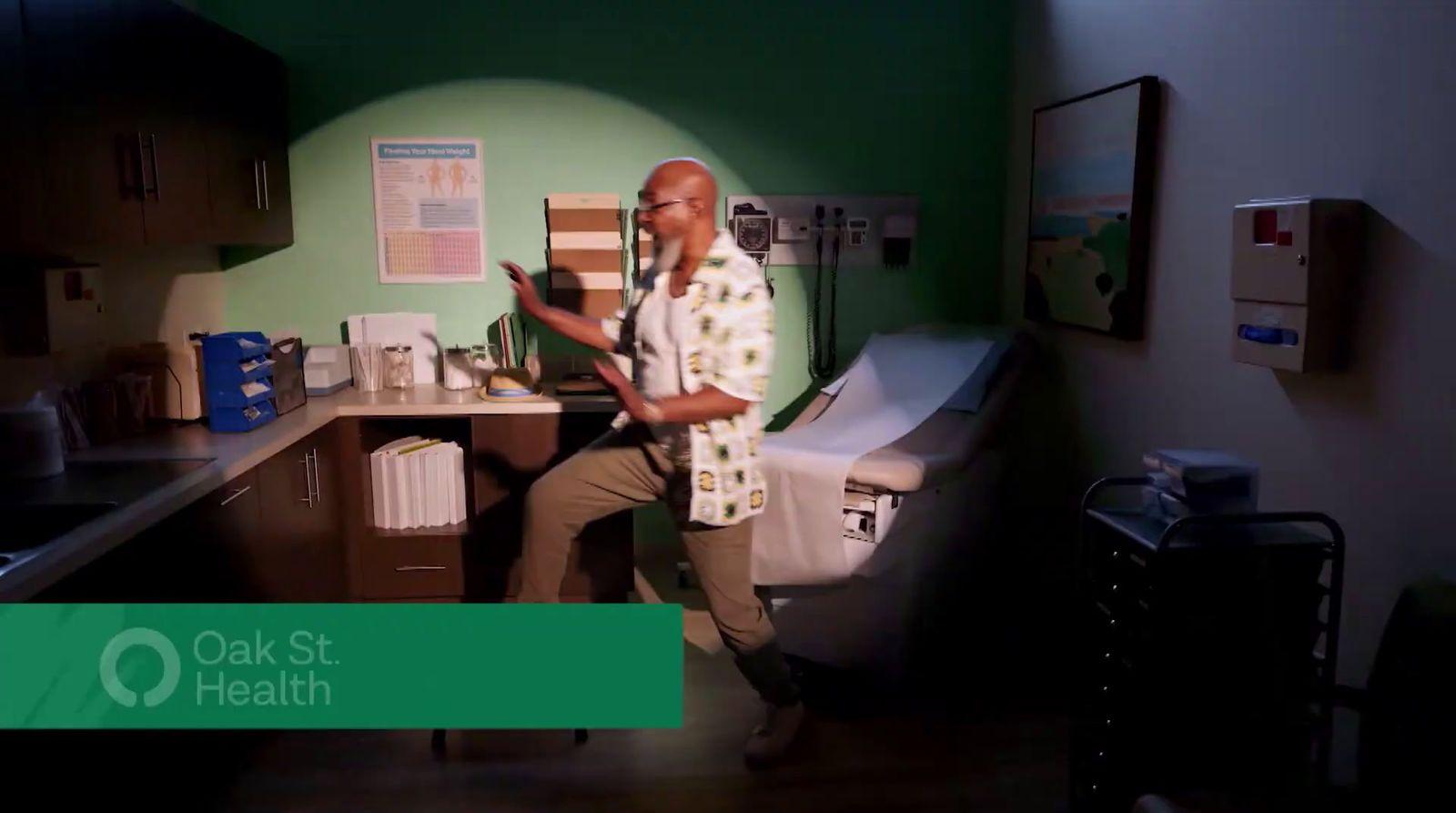 a man sitting at a desk in a green room