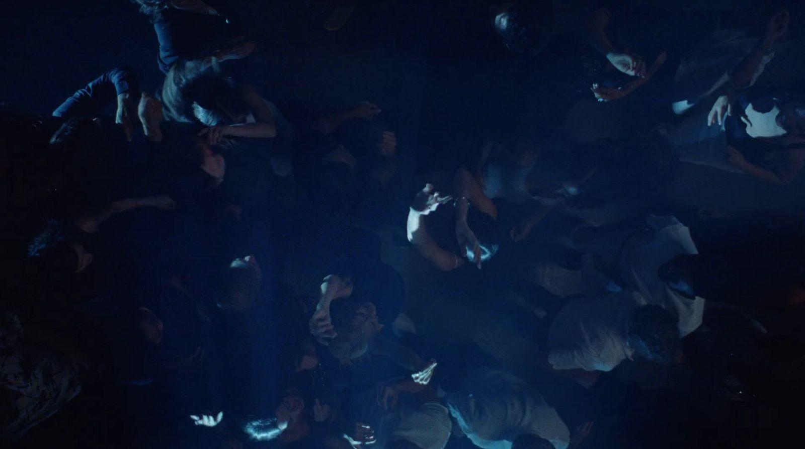 a group of people standing in a dark room