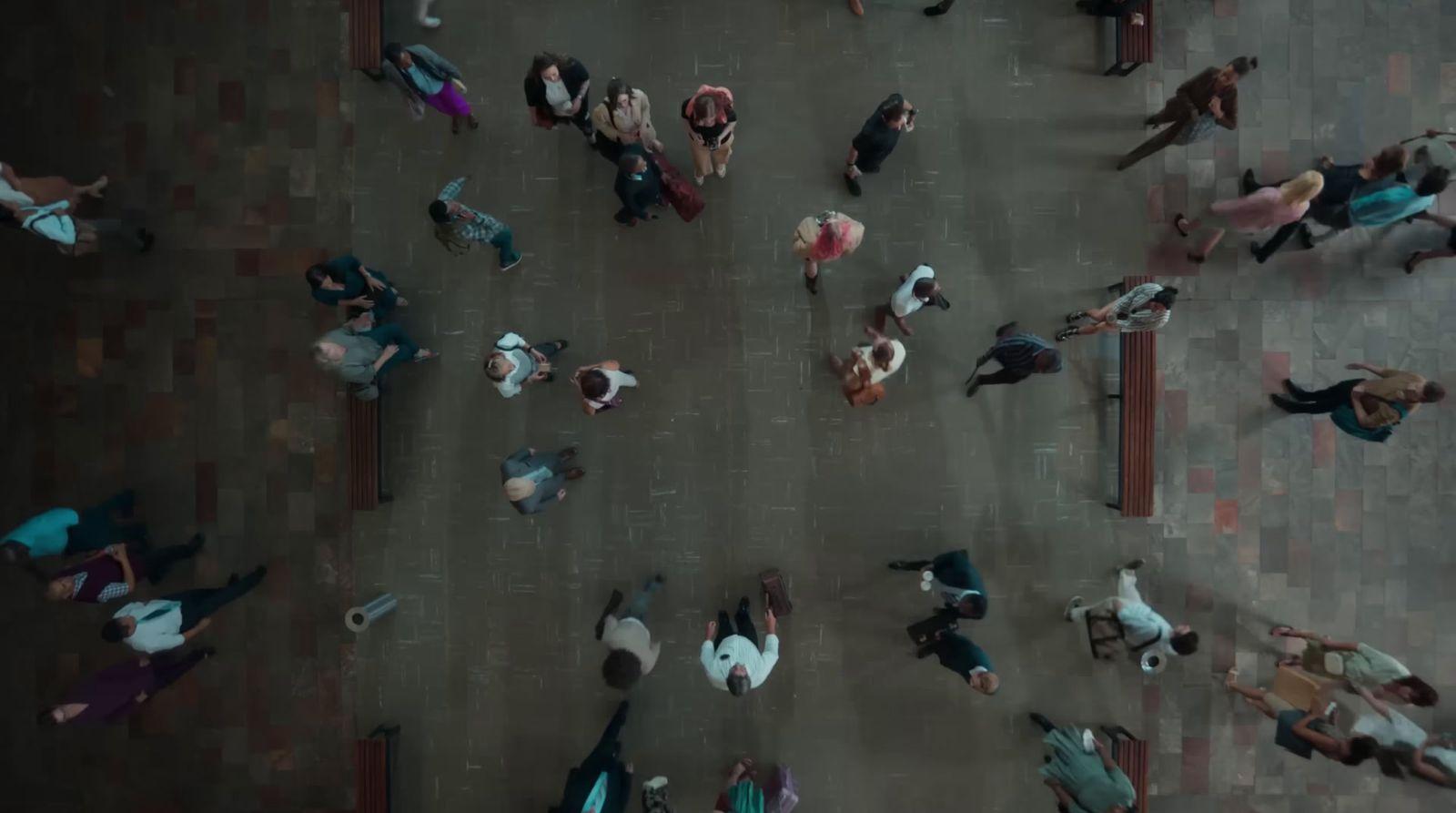 a group of people walking down a street next to each other