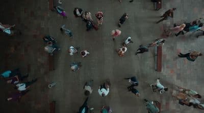 a group of people walking down a street next to each other