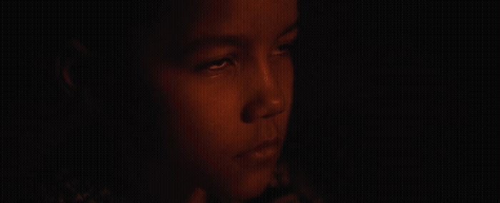 a close up of a woman's face in the dark
