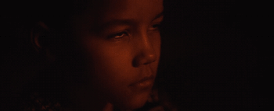 a close up of a woman's face in the dark