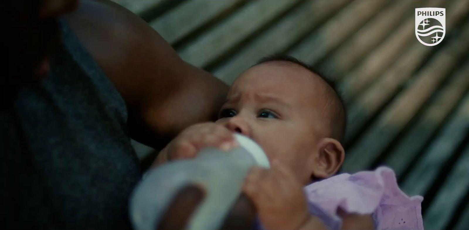 a close up of a person holding a baby