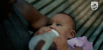 a close up of a person holding a baby