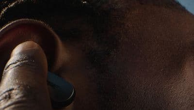 a close up of a person with a pair of ear phones