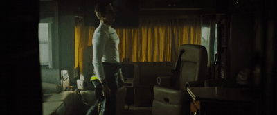 a man standing in a room with a suitcase