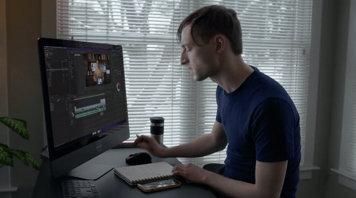 a man sitting in front of a computer monitor