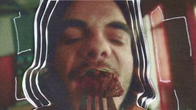 a man eating a piece of food with a fork
