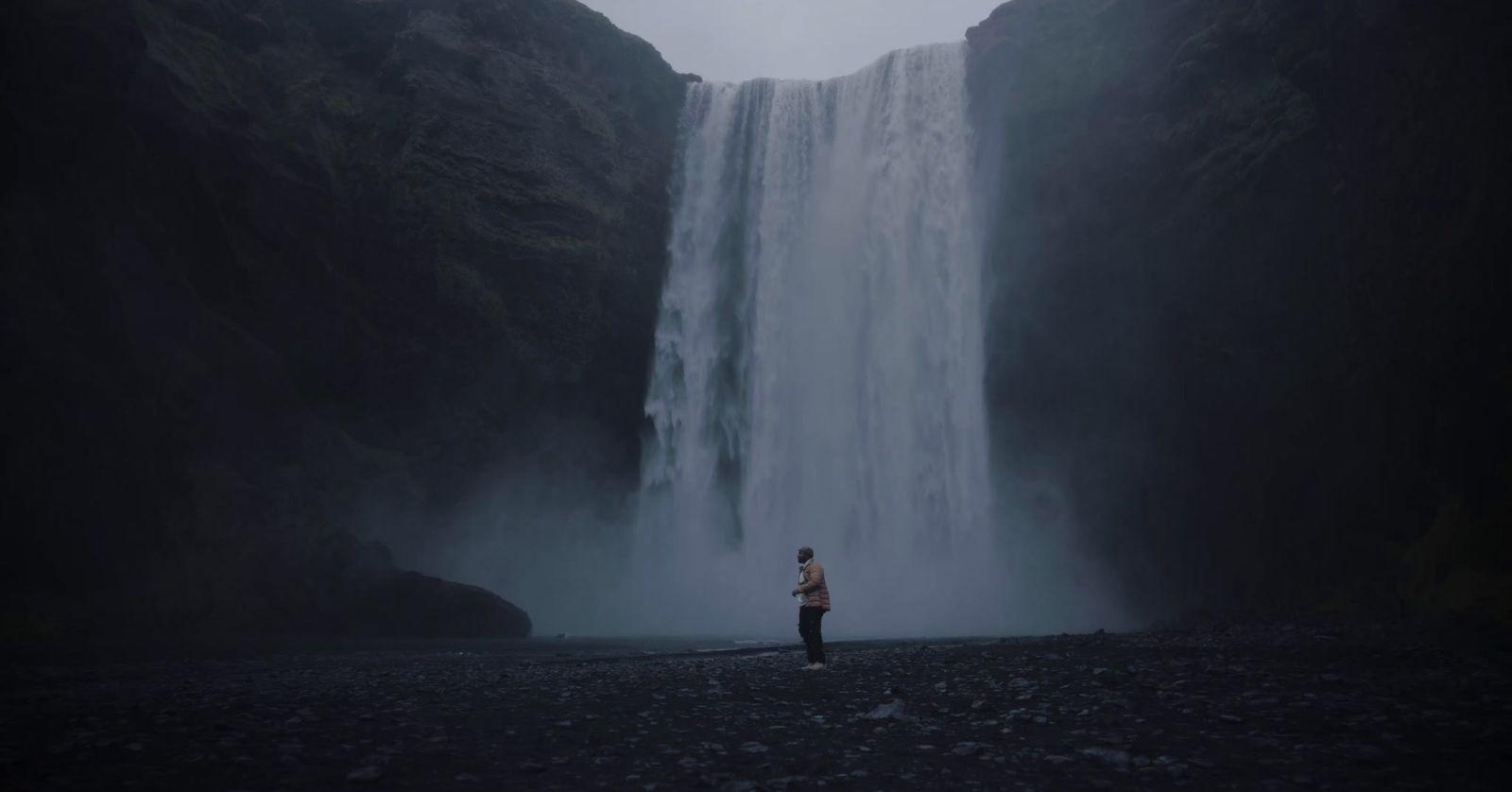 a person standing in front of a waterfall