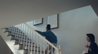 a man and a woman walking up a stair case