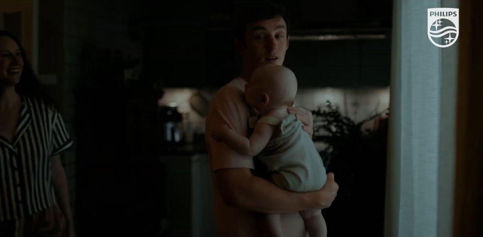 a man holding a baby in his arms