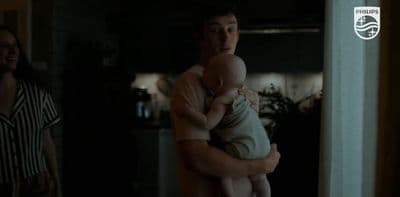 a man holding a baby in his arms