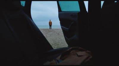a man standing in the middle of a field