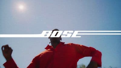 a man in a red shirt is holding a frisbee