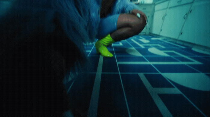 a woman in a blue coat and neon green boots