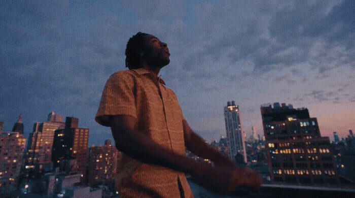a man standing in front of a city skyline