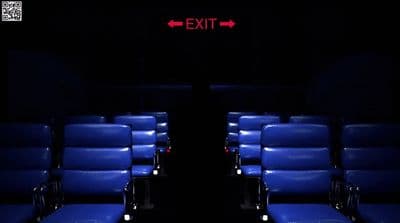 a row of blue chairs sitting next to each other