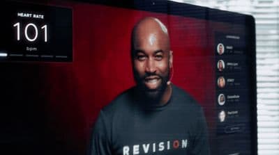 a man in a black shirt is in front of a television