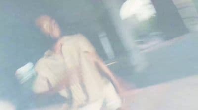 a blurry image of a man walking down the street