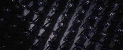 a group of people standing in the middle of a street