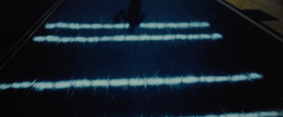 a person walking down an escalator at night