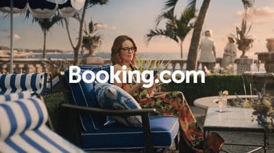 a woman sitting in a chair on the beach