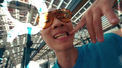a man wearing sunglasses and pointing at something