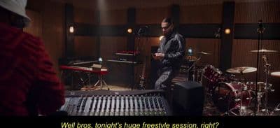 a man standing in front of a recording equipment